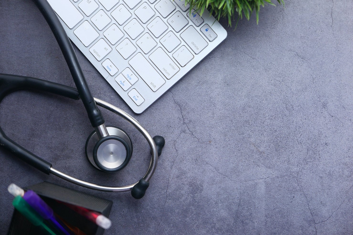 Medical Stethoscope and Keyboard on Black Background